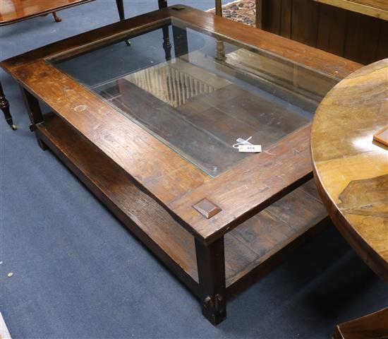 A glass topped hardwood coffee table W.160cm H.50cm